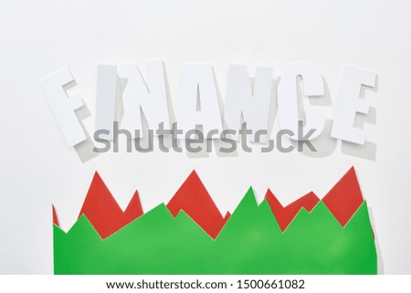 top view of finance inscription with red and green statistic graphs on white background