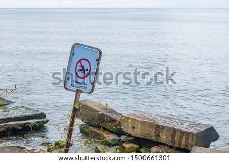 sea, sign: swimming is forbidden