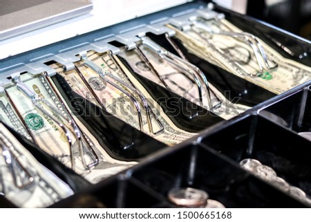 Cash register filled with money and coins Royalty-Free Stock Photo #1500665168
