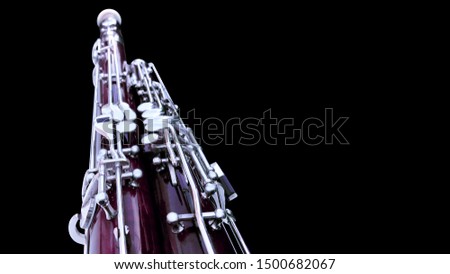 Bassoon. Part of a wind musical instrument on a black background with place for text. Royalty-Free Stock Photo #1500682067