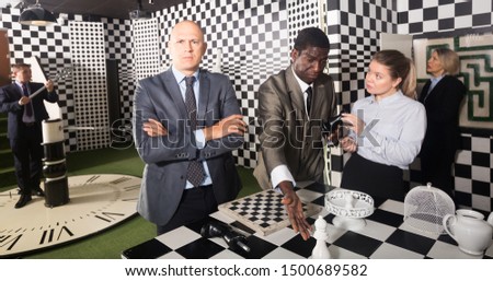Portrait of confused thinking man in business suit in escape room
