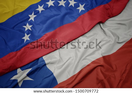 waving colorful flag of chile and national flag of venezuela. macro