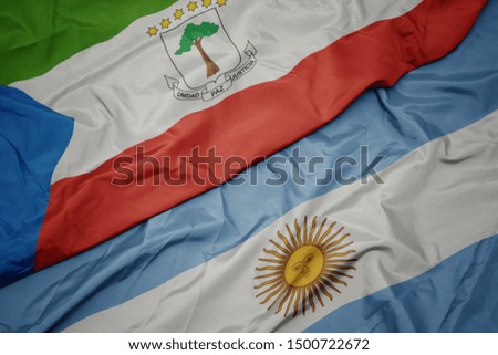 waving colorful flag of argentina and national flag of equatorial guinea. macro