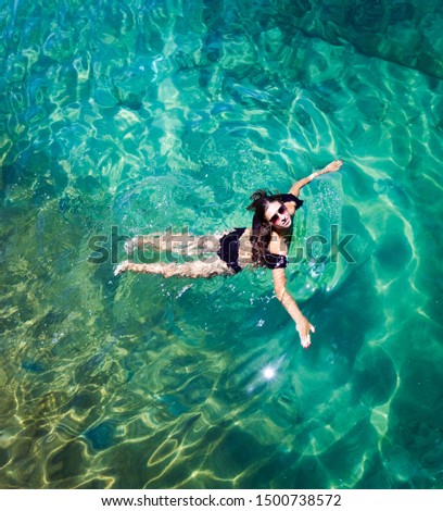 Aerial view of a woman relaxing in the sea 