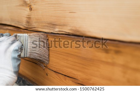 impregnation of a wooden house close up Royalty-Free Stock Photo #1500762425