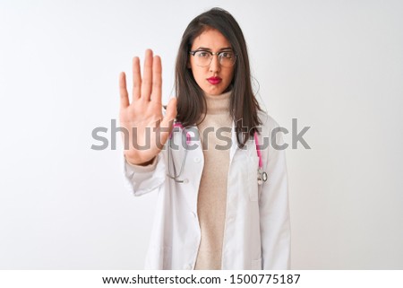 Chinese doctor woman wearing coat and pink stethoscope over isolated white background doing stop sing with palm of the hand. Warning expression with negative and serious gesture on the face.