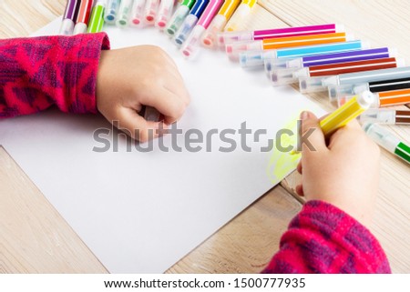 A child draws a birthday card. Drawing made by a child with colorful felt-tip pens. A happy family. Children's drawing.