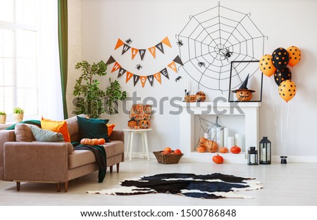 interior of the house decorated for Halloween pumpkins, webs and spiders
