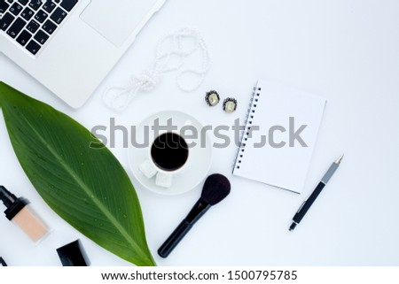 Flat lay girly, pale black items for planning, notepads, pens, office work or working at home on her laptop, on the pale white background, with place for labels. Concept Desk.