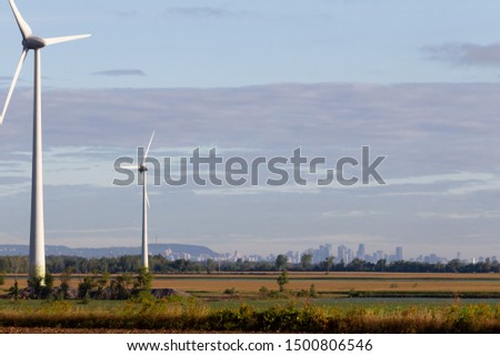 The Montreal skyline with Mount Royal seen here from the wind farm and vast cropped fields of the south shore. The Monteregie region is known for its rich and fertise soil and to be the city's pantry.