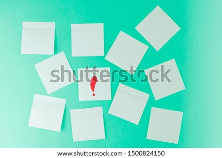 Stickers on a pastel green background. On one sticker is a red exclamation mark. Place for text, notes. Minimalism.