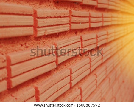 The sun shines on the brick wall
