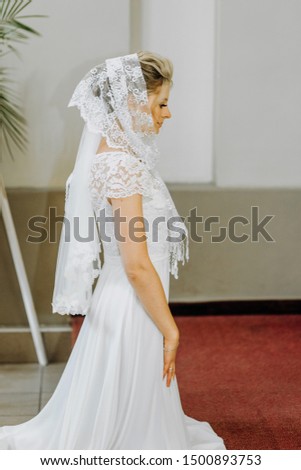 The bridal standing kneeling in front of the icons