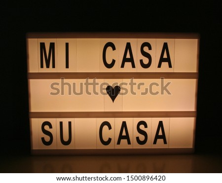 mi casa su casa sign on letter lightbox with dark background