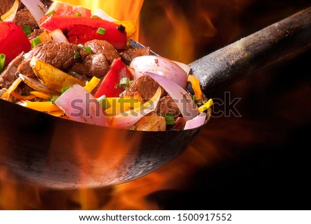 meat and vegetables cooked in wok Royalty-Free Stock Photo #1500917552