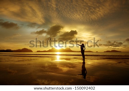 Golden sunset with the girl on the island of El Nido, Philippines.