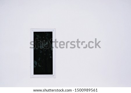 Black window glass designed to intersect with the white color of the wall