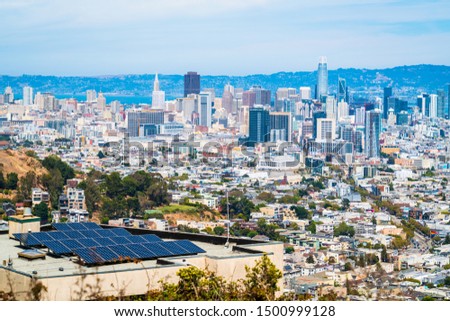 Solar Panels in front of Massive San Francisco Skyline Cityscape Sunny day producing clean renewable energy sustainable future fighting Climate Change 