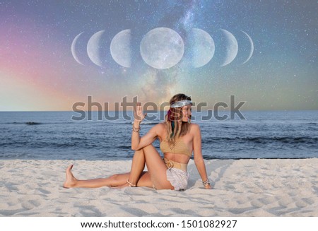 Beautiful woman is practicing yoga on the beach on Milky Way background, starry sky.