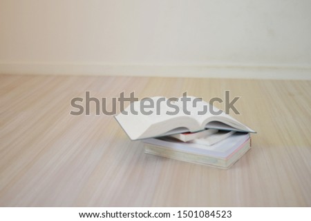 closed-up open book on wood floor