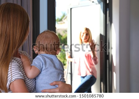 Mother leaving her baby with teen nanny at home. Space for text Royalty-Free Stock Photo #1501085780