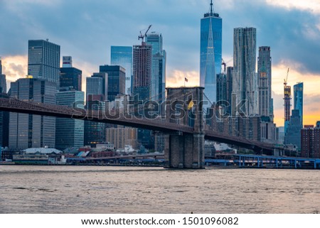 New York skyline view with Brooklyn bridge at sunset