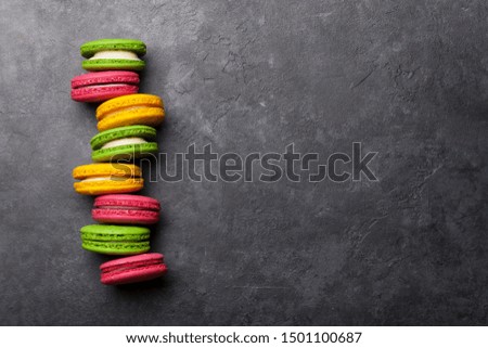 Cake macaron or macaroon sweets on stone backdrop. Top view flat lay with copy space