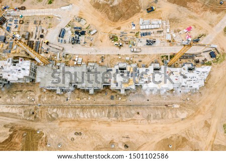 building site with construction crane, machines and equipment. top view aerial photo