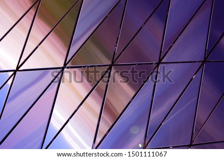 Abstract background of polished metal panels of a triangular shape.