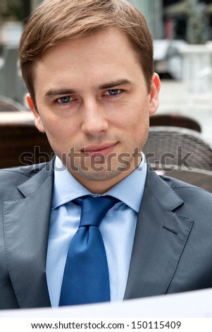 Portrait of a businessman in a restaurant deliberating