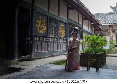 Chinese ancient beauty wearing Chinese clothes play in the Chinese Taoist Taoist Temple.
