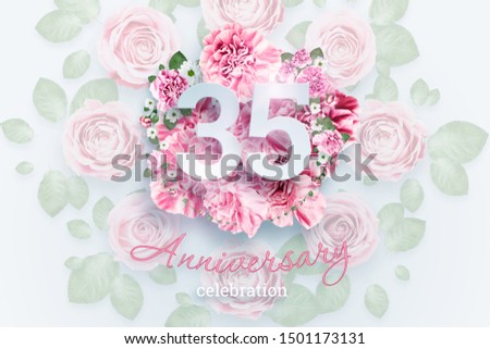 Creative background lettering 35 numbers and anniversary celebration text on pink flowers background. Anniversary concept, birthday, celebration event, template, flyer.