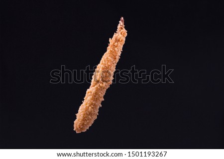 Chicken wings keeping  by man hand in the air isolated 