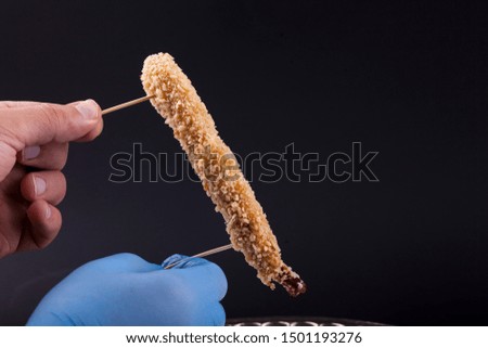 Chicken wings keeping  by man hand in the air isolated 