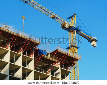 Crane. Self-erection crane over construction site. Crane near bulding. Industrial background.

