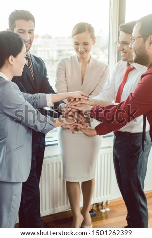 Diversity team of business people in kick-off meeting stacking hands together Royalty-Free Stock Photo #1501262399