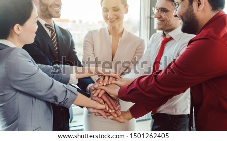Diversity team of business people in kick-off meeting stacking hands together Royalty-Free Stock Photo #1501262405