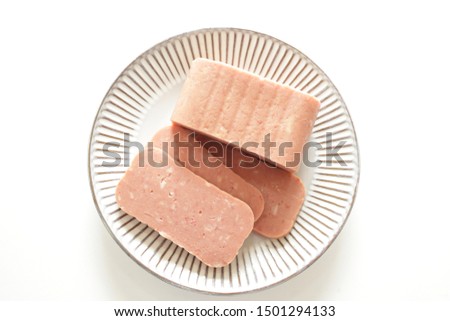 Canned food, luncheon meat sliced on dish Royalty-Free Stock Photo #1501294133