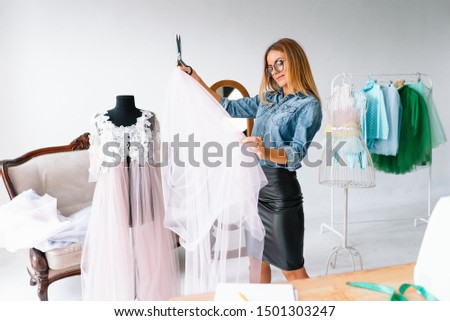 Authentic image of a fashion designer working in her studio