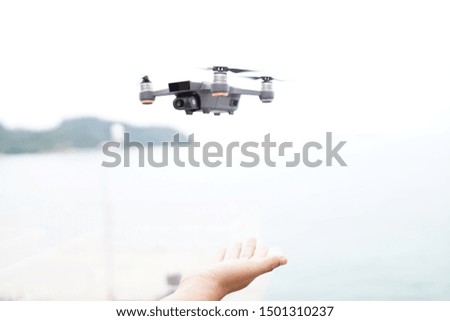 Selective focus on the drone and photographer man hands