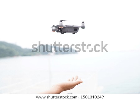Selective focus on the drone and photographer man hands