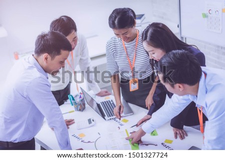 Group of employee worker brainstorm together and use technology together of  tablet and computer laptop, internet lifestyle generation