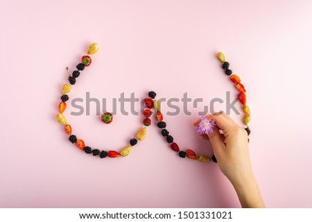 Fresh berries formed as female breasts. Breast cancer health and prevention concept Royalty-Free Stock Photo #1501331021