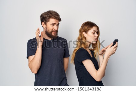 Man and woman with phones in hands communicating fun lifestyle