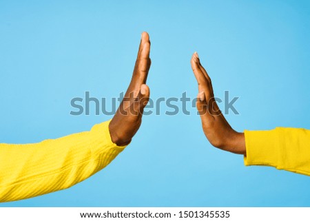 Male and female hand touch palms blue background communication