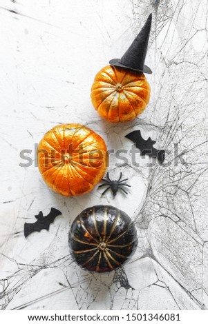 Halloween holiday background with pumpkins, spiders, bats, gifts. Creative festive flat lay.