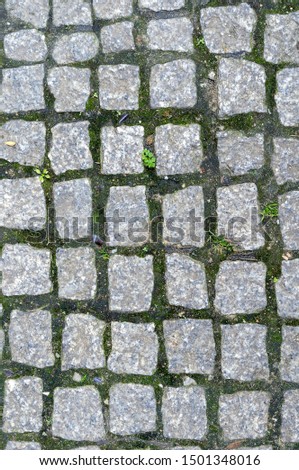 Abstract background of very old cobblestone pavement view from above