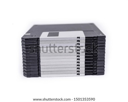 on top of many floppy disk with blank label on white background