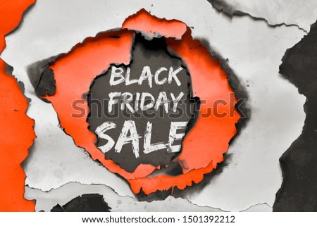 "Black Friday Sale" text in paper hole burned though white, vibrant orange and black color paper, grunge paper banner design
