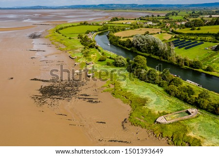 Aerial drone view of abandoned ships on the banks of the River Severn at Purton in England Royalty-Free Stock Photo #1501393649